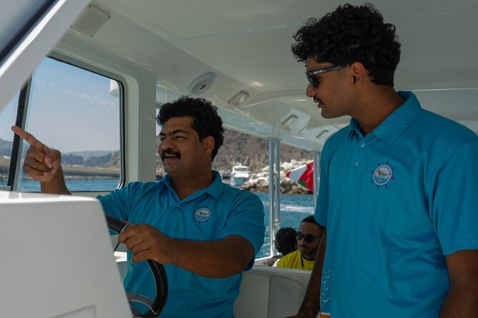 Dolphin Watching and Snorkeling Cruise Experience in Muscat - Leaving Muscat with the coast in view