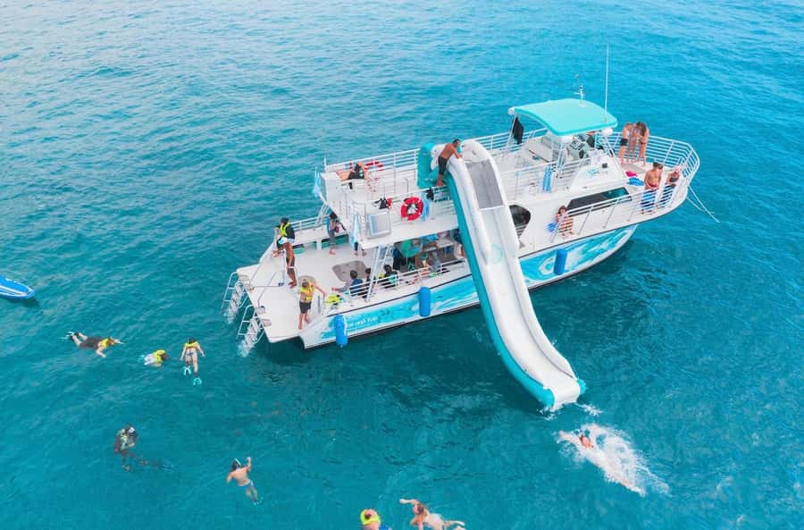 Oahu: Dolphin Watching & Turtle Snorkeling with Waterslide - Watching spinner dolphins from the boat