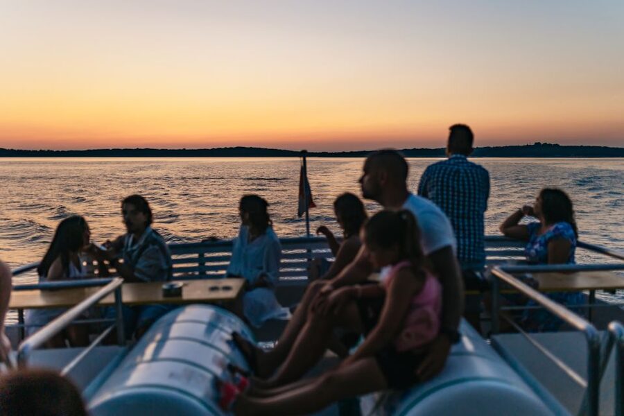 Pula: Dolphin&Sunset Cruise in Brijuni with Dinner&Drinks - Returning to Pula beneath the Lighting Giants